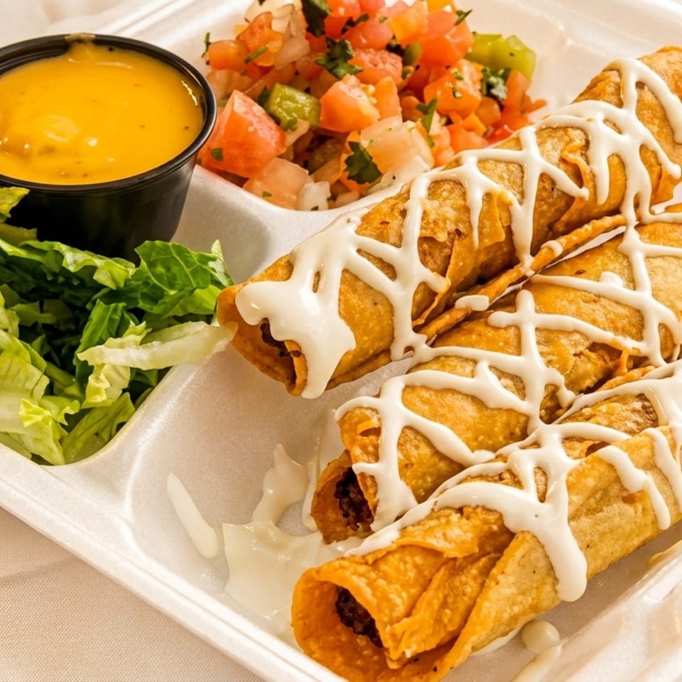 Three taquitos with white sauce, shredded lettuce, cheese dip, and pico de gallo in a takeout container.